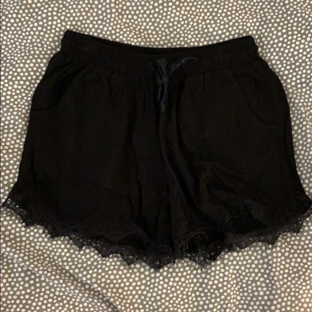 Black fabric shorts with lace detail on bottom
